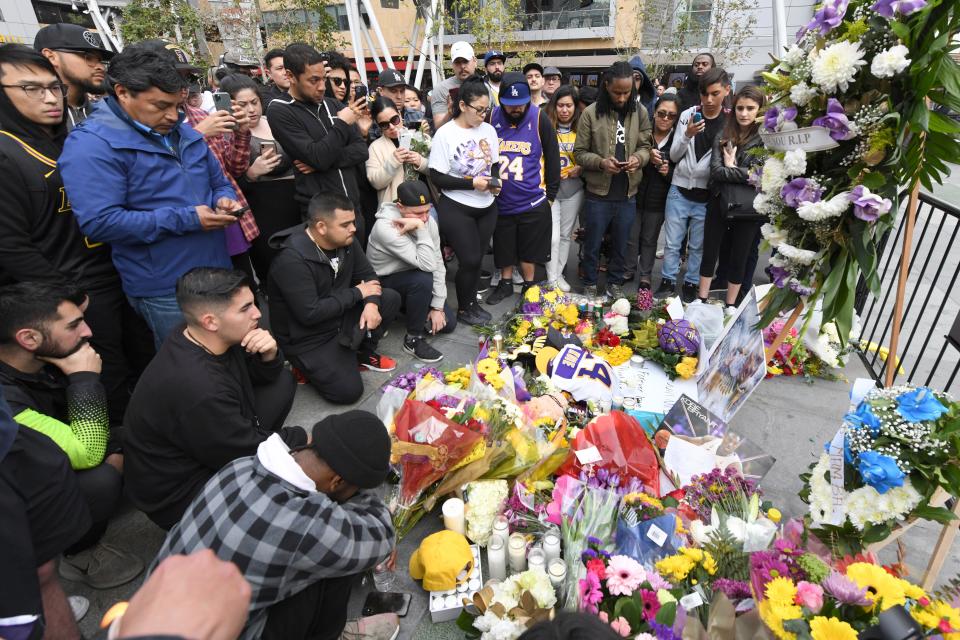 People gather at a makeshift memorial near Staples Center Jan. 26, 2020, after the death of Laker legend Kobe Bryant.