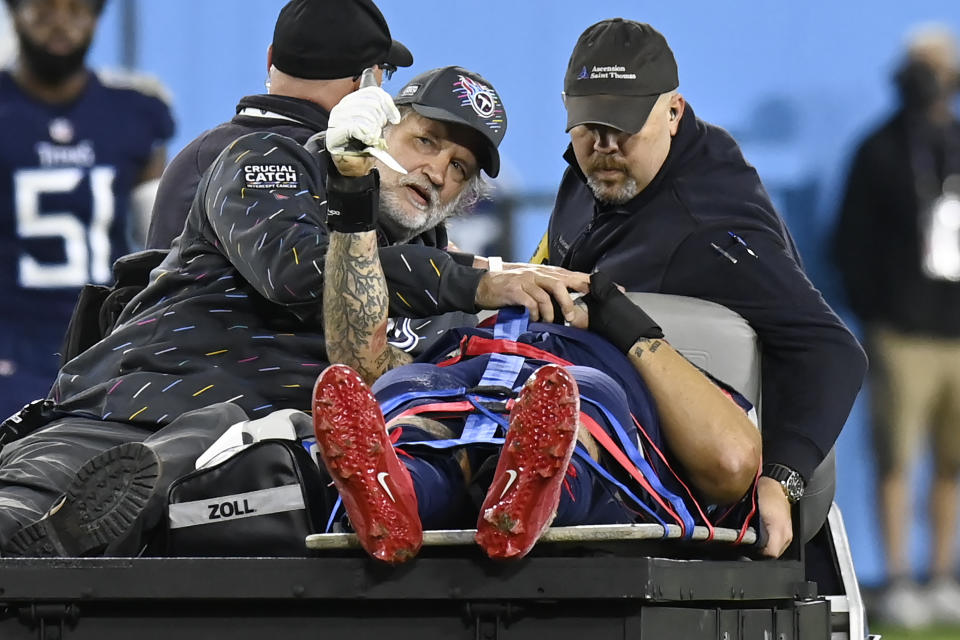 Tennessee Titans offensive tackle Taylor Lewan gives the thumbs up sign as he is taken off the field after being injured against the Buffalo Bills in the first half of an NFL football game Monday, Oct. 18, 2021, in Nashville, Tenn. (AP Photo/Mark Zaleski)