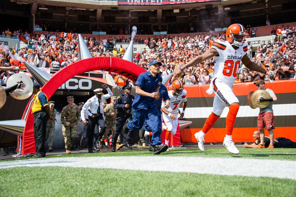 The Cleveland Browns ran out of their tunnel joined by police, firefighters and EMTs. (Photo by Jason Miller/Getty Images)