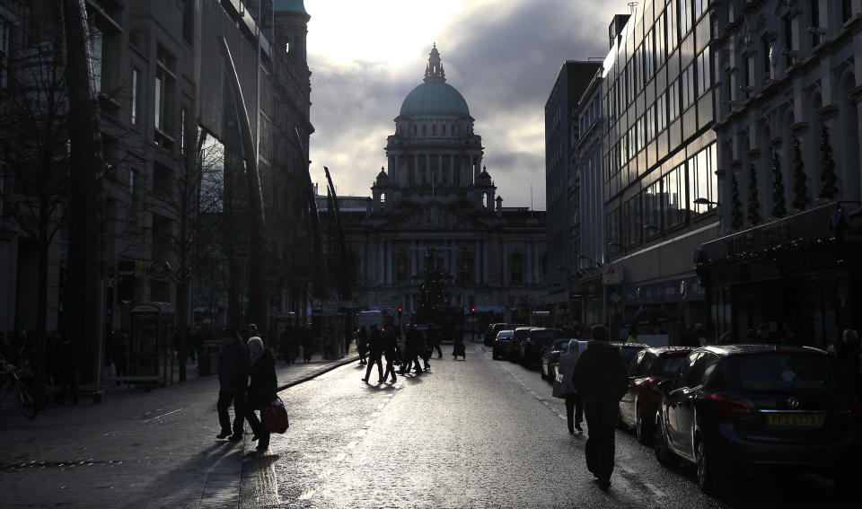 Shoppers make their way around Royal Avenue in front of the city Hall in Belfast December 4, 2012. At least five police officers were wounded during a riot at Belfast city hall in Northern Ireland on Monday after Irish nationalist councillors voted to remove the British flag from the building on all but 17 days of the year.   REUTERS/Cathal McNaughton (NORTHERN IRELAND - Tags: POLITICS RELIGION CITYSPACE)