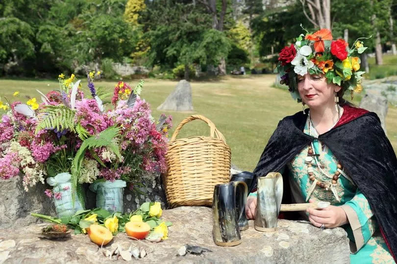 Pagan Wynter Jones with items including flowers and fruit in Happy Valley in Llandudno.