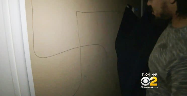 A swastika, which Whitlock had covered in order to protect his son, was drawn on the wall. (Photo: Screengrab, CBS)