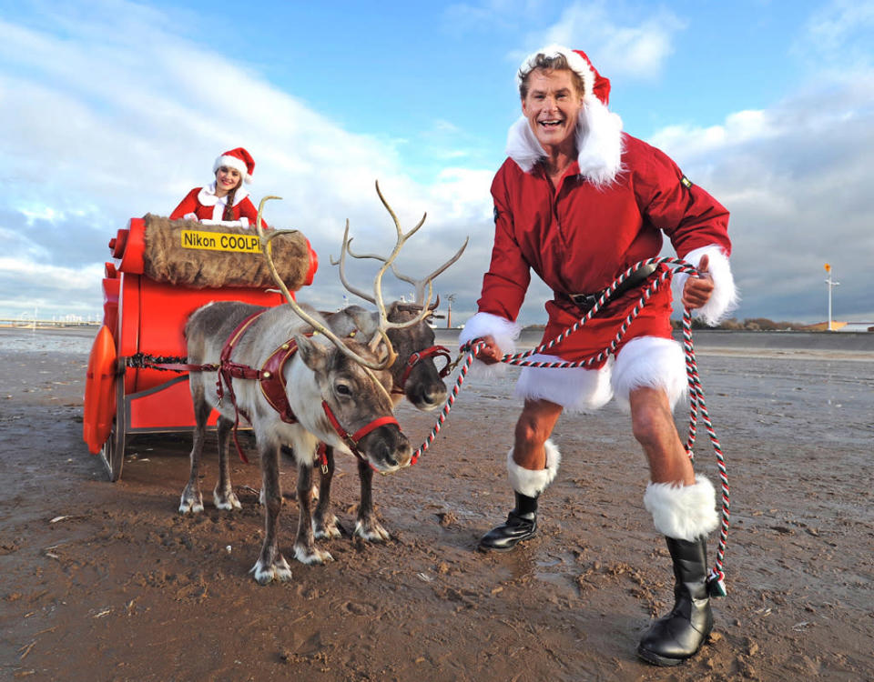 Instead of donning his famous red trunks and lifeguard gear from his "Baywatch" days, 60-year-old David Hasselhoff donned a Santa suit and drove a sleigh full of Christmas gifts and decorations along the shore of Southport, England, on Monday. The photo shoot followed a survey of Britons by Nikon Coolpix, which named Hasselhoff the celebrity people would most like to have their photo taken with in place of Santa. Really? (12/3/2012)