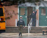 <p>A policeman gives a thumbs-up after moving students into a different area of Great Mills High School, the scene of a shooting, Tuesday morning, March 20, 2018 in Great Mills, Md. (Photo: Alex Brandon/AP) </p>