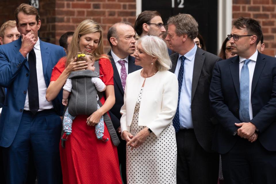 Carrie Johnson holding her daughter Romy, with Nadine Dorries, watches Prime Minister Boris Johnson read a statement outside 10 Downing Street, London, formally resigning as Conservative Party leader after ministers and MPs made clear his position was untenable. He will remain as Prime Minister until a successor is in place. Picture date: Thursday July 7, 2022. (PA Wire)
