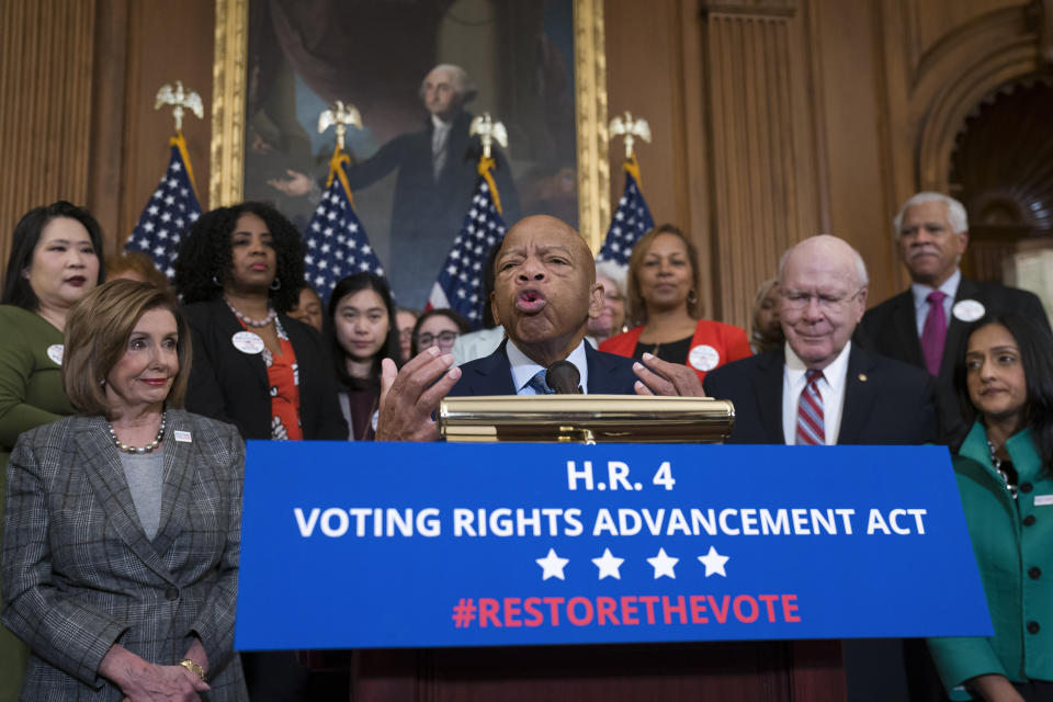 Civil rights leader Rep. John Lewis, D-Ga., flanked by Speaker of the House Nancy Pelosi, D-Calif., left, and Sen. Patrick Leahy, D-Vt., speaks at an event with House Democrats before passing the Voting Rights Advancement Act to eliminate potential state and local voter suppression laws, at the Capitol in Washington on Dec. 6, 2019.  (Photo: J. Scott Applewhite/AP)                               