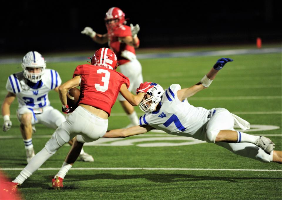 Albany's London Fuentes (3) stiff arms Windthorst's Kolby Teakell (7) after making a catch.