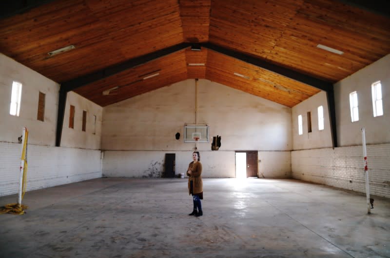 Kendra Miller shows the old basketball court where she used to play as a kid in La Mora