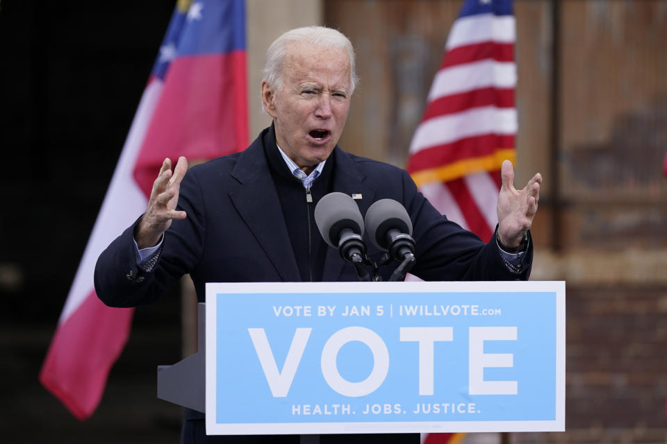 FILE - In this Tuesday, Dec. 15, 2020, file photo, President-elect Joe Biden speaks at a drive-in rally for Georgia Democratic candidates for U.S. Senate Raphael Warnock and Jon Ossoff, in Atlanta. The first full week of 2021 is shaping up to be one of the biggest of Biden’s presidency. And he hasn’t even taken office yet. (AP Photo/Patrick Semansky, File)