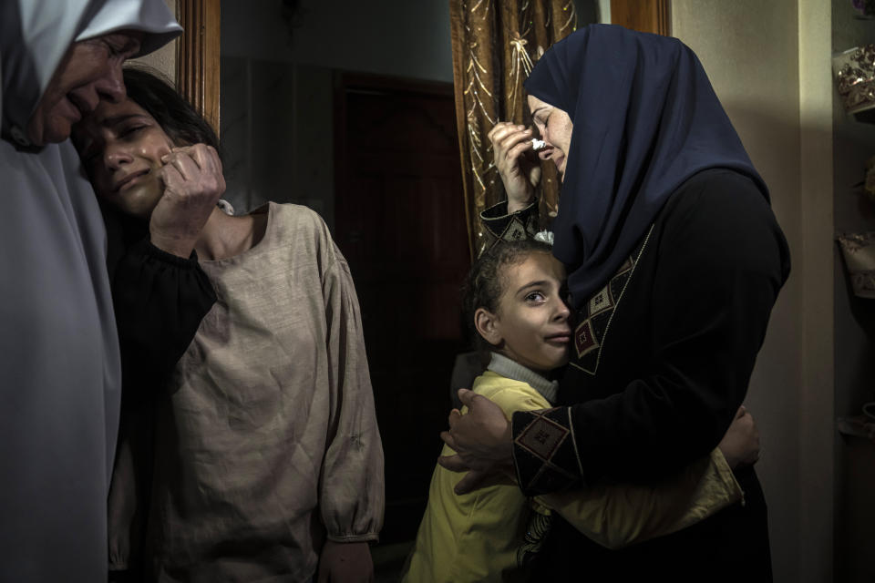 Palestinian relatives mourn for Islamic Jihad commander Ali Ghali and his brother, Mohammed Ghali, both killed in an Israeli airstrike in Khan Younis, southern Gaza Strip, Thursday, May 11, 2023. (AP Photo/Fatima Shbair)