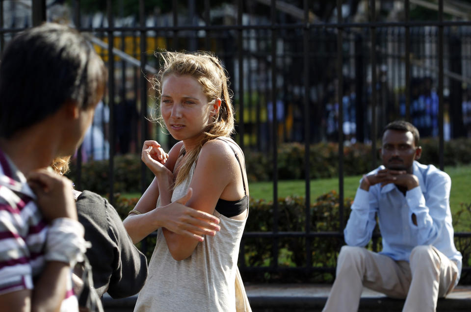 In this Tuesday, April 2, 2013 photo, German tourist Carolina De Paola, 22, walks near the landmark Gateway of India in Mumbai, India. A fatal gang rape in New Delhi didn't deter Germans De Paolo and Canan Wahner from traveling to India for a six-week tour. On a train, a man grabbed De Paolo's breasts from behind but she never reported the crime, deciding there would be no point. Violence against women, and the huge publicity generated by recent attacks here, is threatening India's $17.7 billion tourism industry with a new study showing tourism has plunged. (AP Photo/Rajanish Kakade)