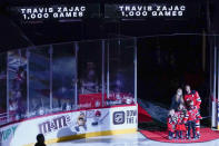 New Jersey Devils center Travis Zajac is joined by his family during a ceremony to celebrate his 1,000 career games with the New Jersey Devils before he start of an NHL hockey game against the Washington Capitals, Saturday, Feb. 27, 2021, in Newark, N.J. (AP Photo/Mary Altaffer)