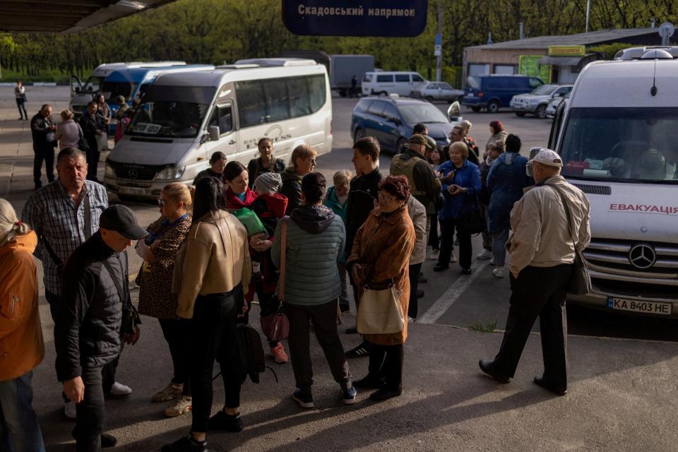 Local residents are seen a during an evacuation effort at a bus station in the outskirts of Kherson (REUTERS)