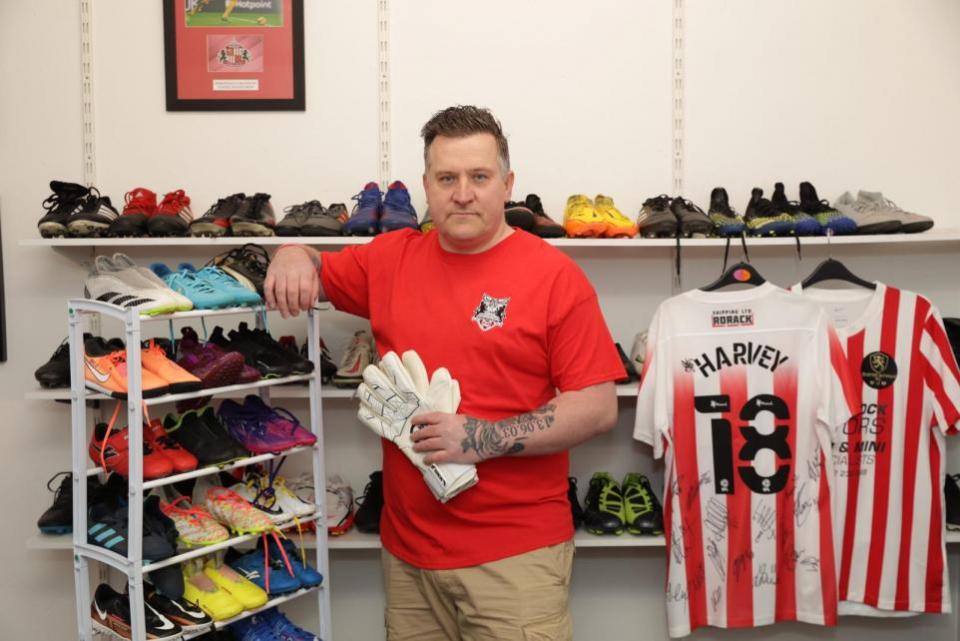 The Northern Echo: Michael at the charity base in Darlington with just some of the boots set to be given away to youngsters.