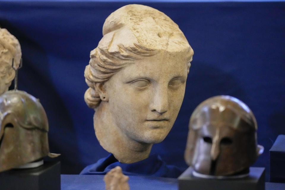 A marble head of Atena, dated to the II century B.C., is seen on display among other archaeological artifacts stolen from Italy and sold in the US by international art traffickers, during a press conference in Rome, Monday, Jan. 23, 2023. 60 stolen artifacts, for an estimated total value of 20 million dollars, have been recovered in private collections in the US and returned to Italy after a joint investigation by Italian Carabinieri police and the New York County District Attorney's Office. (AP Photo/Andrew Medichini)