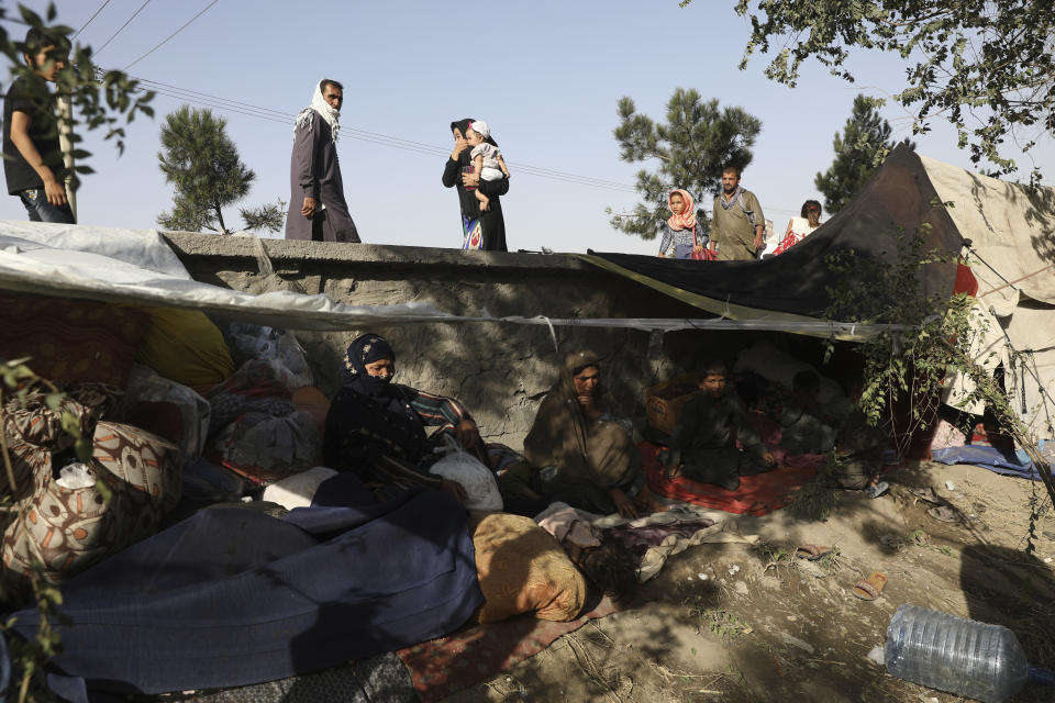 Internally displaced Afghans from northern provinces, who fled their home due to fighting between the Taliban and Afghan security personnel, take refuge in a public park Kabul, Afghanistan, Friday, Aug. 13, 2021. The Taliban have completed their sweep of the country's south on Friday, as they took four more provincial capitals in a lightning offensive that is gradually encircling Kabul, just weeks before the U.S. is set to officially end its two-decade war. (AP Photo/Rahmat Gul)