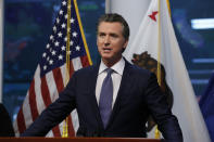 Gov. Gavin Newsom updates the state's response to the coronavirus at the Governor's Office of Emergency Services in Rancho Cordova, Calif., Monday, March 23, 2020. Newsom said he would close parking lots at dozens of beaches and state parks to prevent the spread of coronavirus after large groups flocked to the coast and mountains to get outdoors on the first weekend since the state's stay-at-home order took effect. (AP Photo/Rich Pedroncelli, Pool)