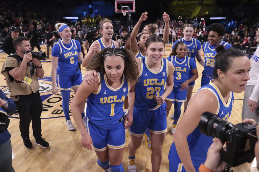 UCLA guard Kiki Rice (1) and forward Gabriela Jaquez (23) head off the court after defeating UCLA.