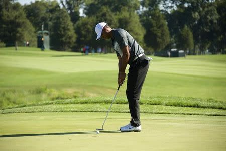 Tiger Woods putts on the 15th hole in the second round of the Quicken Loans National golf tournament at Robert Trent Jones Golf Club. Mandatory Credit: Rafael Suanes-USA TODAY Sports