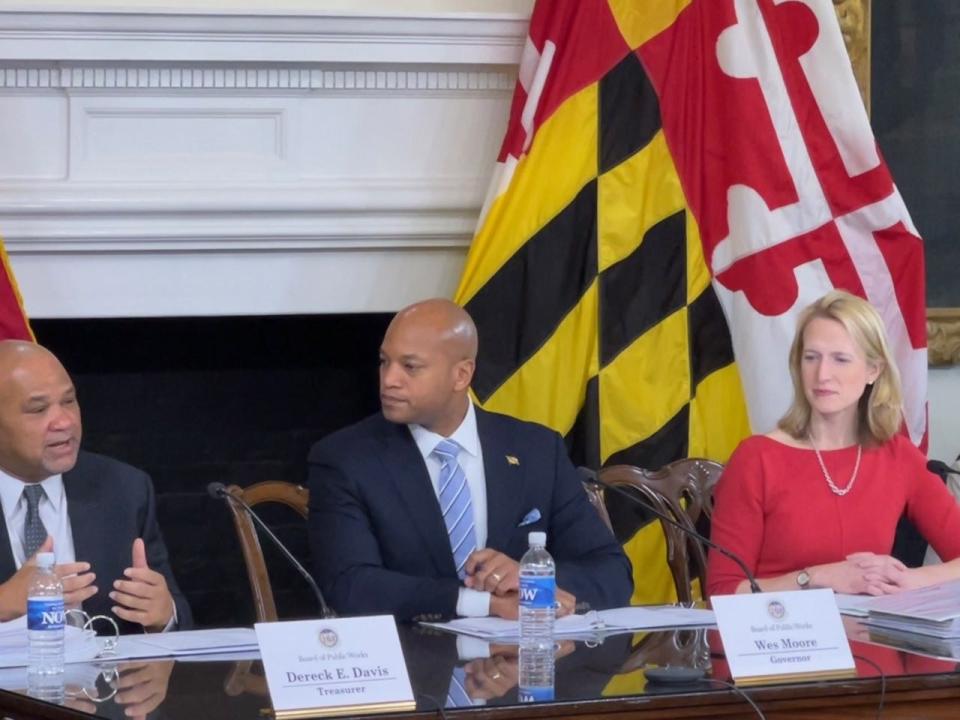 State Treasurer Dereck Davis, left, speaks during a Board of Public Works meeting in Annapolis, Maryland on Jan. 25, 2023. During their first meeting, Gov. Wes Moore, center, and Comptroller Brooke Lierman, right, voted unanimously with board veteran Davis on millions of dollars in state grants.