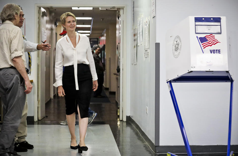 Polling station officials direct New York gubernatorial candidate Cynthia Nixon to her voting area for the primary, Thursday, Sept. 13, 2018, in New York. Democrats across New York state are picking the winner of a long and sometimes nasty primary contest between Gov. Andrew Cuomo and activist and former "Sex and the City" star Nixon. (AP Photo/Bebeto Matthews)