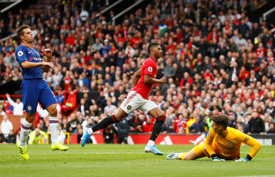 Soccer Football - Premier League - Manchester United v Chelsea - Old Trafford, Manchester, Britain - August 11, 2019  Manchester United's Marcus Rashford celebrates scoring their third goal as Chelsea's Cesar Azpilicueta and Kepa Arrizabalaga look dejected   Action Images via Reuters/Jason Cairnduff  EDITORIAL USE ONLY. No use with unauthorized audio, video, data, fixture lists, club/league logos or "live" services. Online in-match use limited to 75 images, no video emulation. No use in betting, games or single club/league/player publications.  Please contact your account representative for further details.