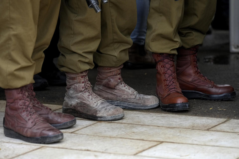 Israeli soldiers take part in the funeral of Israeli Defense Forces Sgt. Rotem Sahar Hadar, a Paratrooper who was killed in action in the Gaza Strip, at the military cemetery in Gedera, Israel, Friday, Feb. 16, 2024. (AP Photo/Tsafrir Abayov)