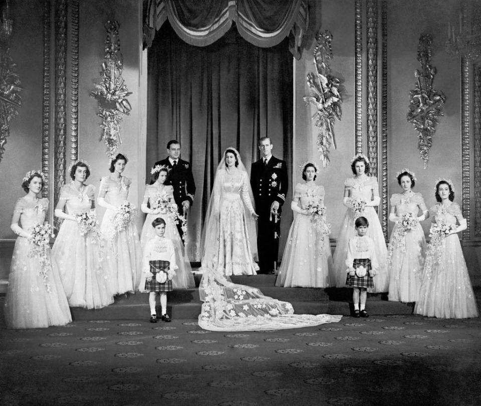 Princess Elizabeth and the Duke of Edinburgh with their eight bridesmaids in the Throne Room at Buckingham Palace on their wedding day (PA)