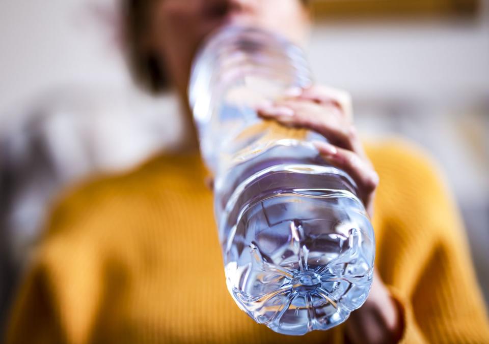 woman drinking mineral water from the bottle