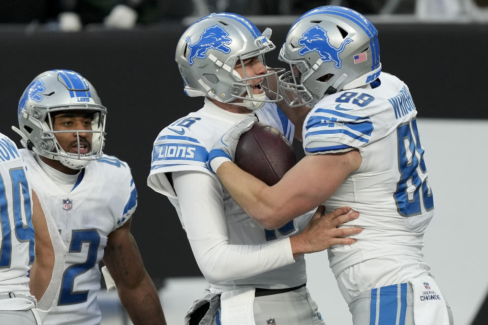 Detroit Lions tight end Brock Wright (89) celebrates with quarterback Jared Goff (16) after scoring a touchdown against the New York Jets during the fourth quarter of an NFL football game, Sunday, Dec. 18, 2022, in East Rutherford, N.J. (AP Photo/Bryan Woolston)