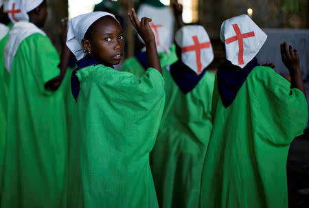 A Congolese girl prays during Sunday mass in the village of Mweso in eastern Democratic Republic of Congo February 8, 2009. REUTERS/Finbarr O'Reilly/File Photo