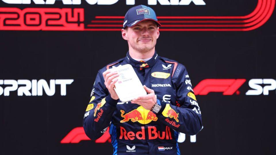 Max Verstappen holds up his medal for winning the sprint in China 