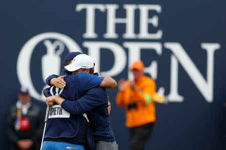 USA's Jordan Spieth celebrates with his caddie after holing a putt on the 18th green to win The Open Championship REUTERS/Andrew Boyers