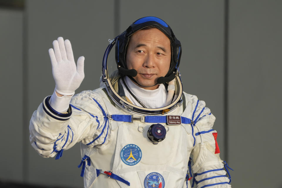 Jing Haipeng, mission commander for the Shenzhou-16 mission waves during a send-off ceremony for his manned space mission at the Jiuquan Satellite Launch Center in northwestern China, Tuesday, May 30, 2023. (AP Photo/Mark Schiefelbein)