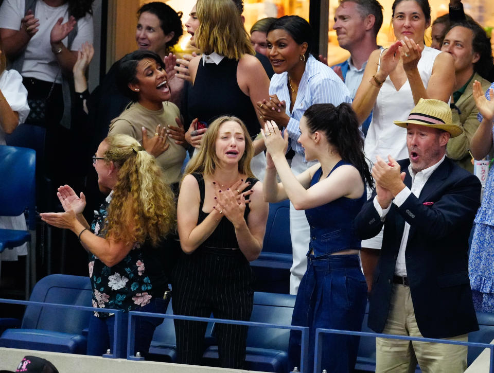 Amanda Seyfried with her hands on her heart