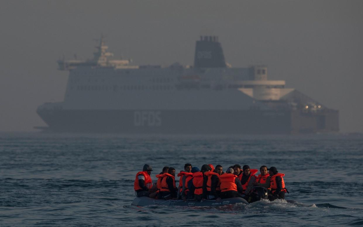 An inflatable craft carrying migrant men, women and children crosses the shipping lane in the English Channel - Getty Images /Dan Kitwood