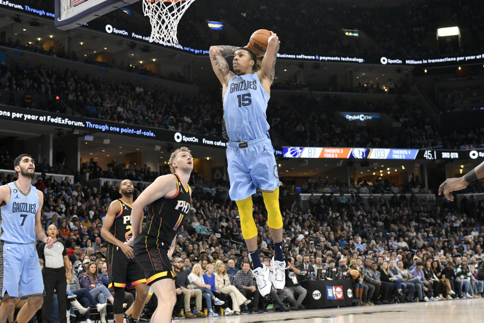 Memphis Grizzlies forward Brandon Clarke (15) goes up for a dunk ahead of Phoenix Suns center Jock Landale (11) in the second half of an NBA basketball game Monday, Jan. 16, 2023, in Memphis, Tenn. (AP Photo/Brandon Dill)