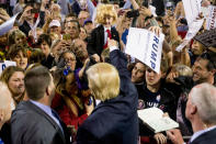 <p>Trump gestures to Colton Jordan, 5, of Cario, Ga., center, who dressed up like Trump, following a rally at Valdosta State University in Valdosta, Ga., Feb. 29, 2016. <i>(Photo: Andrew Harnik/AP)</i> </p>