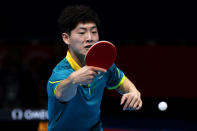 LONDON, ENGLAND - JULY 28: Justin Han of Australia plays a backhand against Mawussi Agbetoglo of Togo during their Men's Singles Table Tennis match on day one of the London 2012 Olympic Games at ExCeL on July 28, 2012 in London, England. (Photo by Feng Li/Getty Images)