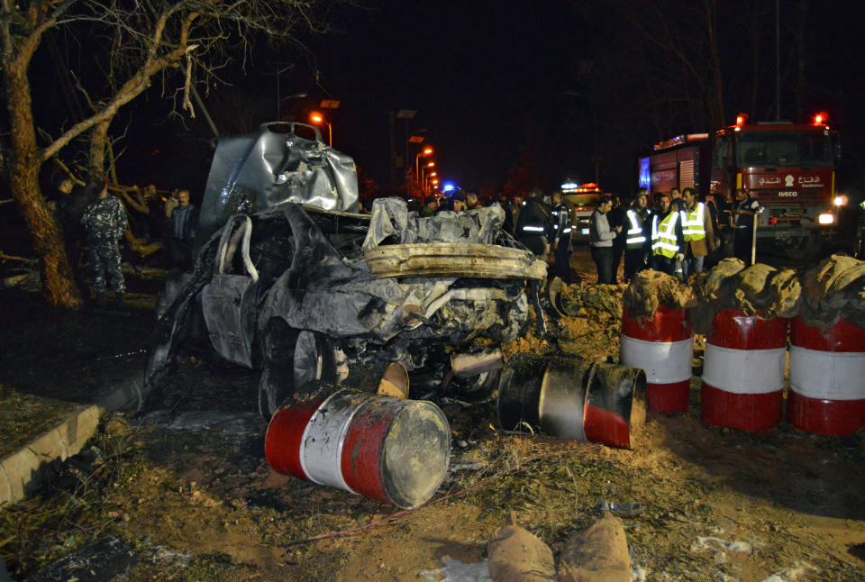 Lebanese army and citizens gather at the site of an explosion, in the predominately Shiite town of Hermel, about 10 miles (16 kilometers) from the Syrian border in northeast Lebanon, Saturday, Feb. 22, 2014. A suicide attacker blew himself up at an army checkpoint after troops tried to search his car Saturday, killing and wounding a number of people including soldiers in the latest blast linked to Syria's civil war, a senior military official and the state news agency said. (AP Photo)