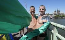 Scott and Brad from Australia meet as participants of the Cologne Pride rally in Cologne, Germany, Sunday, July 3, 2022. This year's Christopher Street Day (CSD) Gay Parade with thousands of demonstrators for LGBTQ rights is the first after the coronavirus pandemic to be followed by hundreds of thousands of spectators in the streets of Cologne. (AP Photo/Martin Meissner)