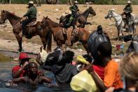 FILE PHOTO: Asylum-seeking migrants in the U.S. return to the Mexican side of the border, in Ciudad Acuna