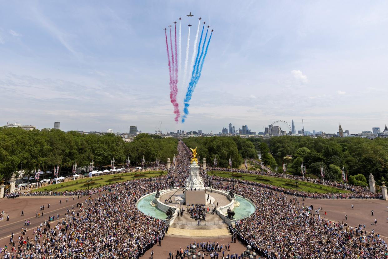 The Red Arrows, flanking an envoy of the RAF, approach Buckingham Palace during a flypast on the day of Trooping the Colour (via REUTERS)