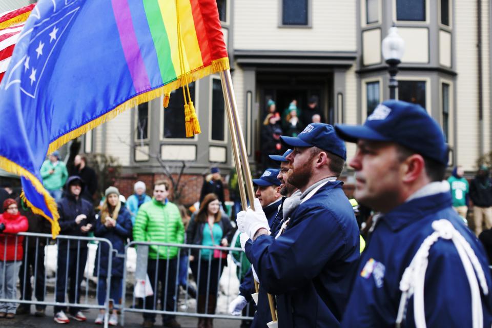 REFILE - CORRECTING STATE The color guard for LGBT veterans group OutVets marches down Broadway during the St. Patrick's Day Parade in South Boston, Massachusetts March 15, 2015. For the first time in the 114-year history of Boston's St. Patrick's Day parade, gay rights activists marched openly on Sunday under rainbow banners in the city's annual celebration of its Irish heritage, after organizers lifted a longtime ban. Two groups, Boston Pride and OutVets, were among dozens of contingents taking part in the parade through the center of South Boston, once an insular Irish-American neighborhood near downtown that has undergone gentrification in recent years. REUTERS/Dominick Reuter (UNITED STATES - Tags: SOCIETY ANNIVERSARY)