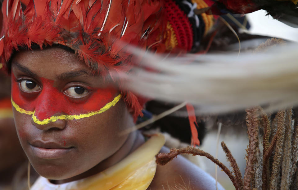 In this Thursday, Nov. 15, 2018, file photo, dancers in traditional dress wait for the arrival of Chinese President Xi Jinping in Port Moresby, Papua New Guinea. Xi arrives in the country for a state visit ahead of their annual APEC meeting. (AP Photo/Aaron Favila, File)