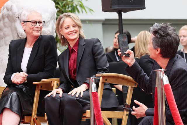 <p>Rodin Eckenroth/Getty</p> Alexandra Hedison takes a photo of Jamie Lee Curtis and Jodie Foster