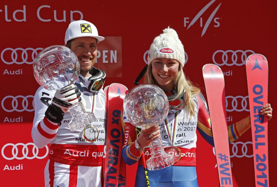World Cup overall men's 2017 champion Austria's Marcel Hirscher, left, and World Cup overall women's 2017 champion United States' Mikaela Shiffrin hold their crystal globe trophies on the podium after a World Cup ski race Sunday, March 19, 2017, in Aspen, Colo. (AP Photo/Nathan Bilow)