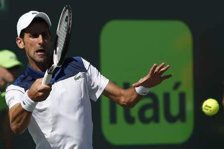 Mar 23, 2018; Key Biscayne, FL, USA; Novak Djokovic of Serbia hits a forehand against Benoit Paire of France (not pictured) on day four of the Miami Open at Tennis Center at Crandon Park. Paire won 6-3, 6-4. Mandatory Credit: Geoff Burke-USA TODAY Sports