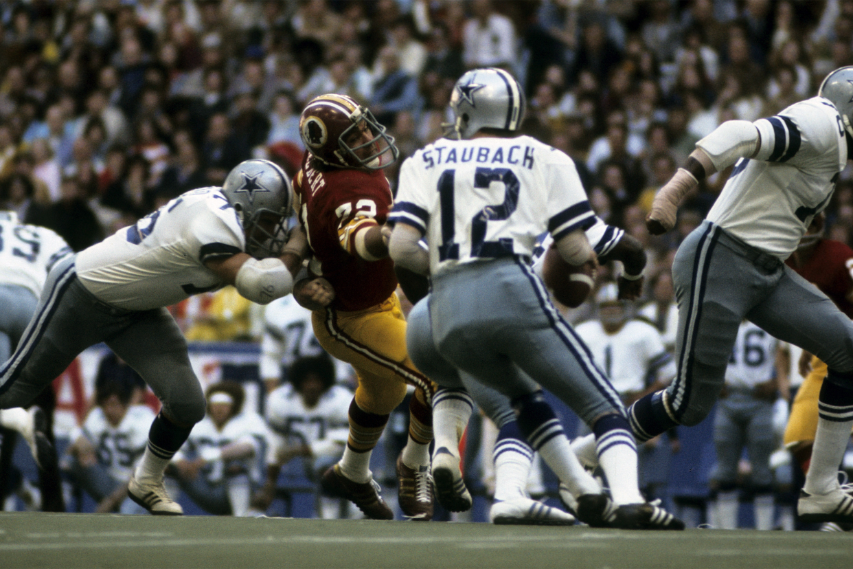 Hall of Fame quarterback Roger Staubach of the Dallas Cowboys looks for an open receiver downfield during the Cowboys 24-23 Thanksgiving Day victory over the Washington Redskins on November 28, 1974 at Texas Stadium in Irving, Texas.