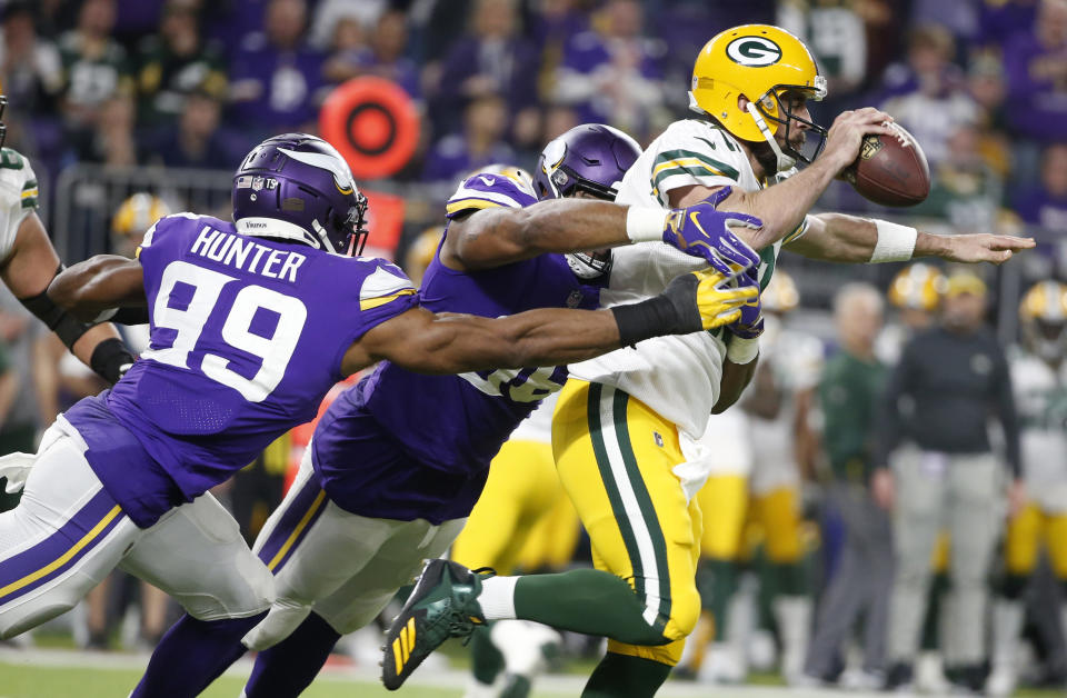 Green Bay Packers quarterback Aaron Rodgers is sacked by Minnesota Vikings defenders Danielle Hunter (99) and Tom Johnson. (AP)